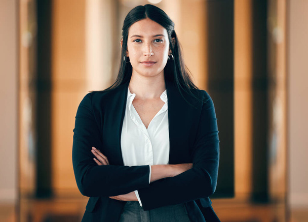 Shot of a young businesswoman standing with her arms crossed at work. - Foto, afbeelding