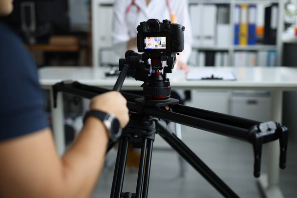 Videographer filming doctor on medical remote training. Online lessons in medicine concept - 写真・画像