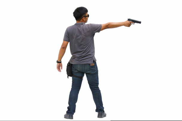Spion man in de missie, Killer missie, portret van jonge Man met geweer op witte achtergrond - Foto, afbeelding