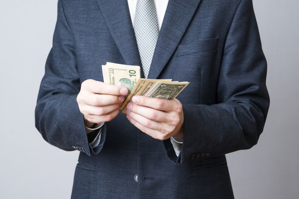Businessman with money in studio - Fotó, kép