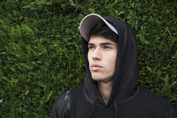 Attractive young man with hoodie and baseball cap - Fotoğraf, Görsel