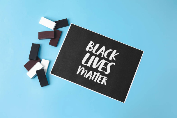 Black, white blocks and paper sheet with text BLACK LIFE MATTERS on color background - Fotoğraf, Görsel
