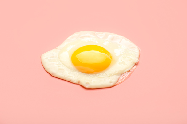 Tasty fried egg on color background - Foto, imagen