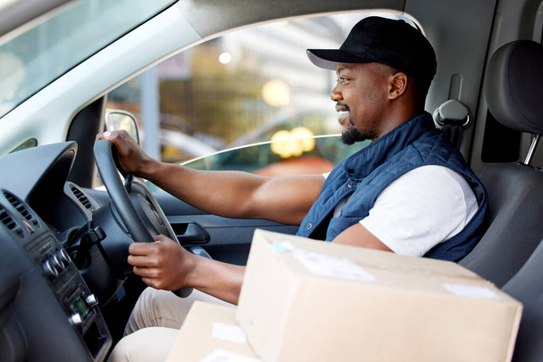 Shot of young man delivering a package while sitting in a vehicle. - Foto, Imagem