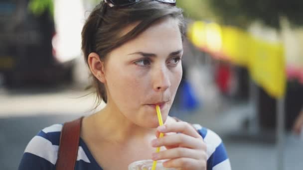 4k video footage of a young woman enjoying some orange juice while out and about in the city. - Imágenes, Vídeo
