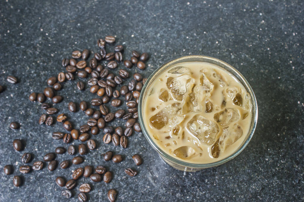 Coffee ice in a glass with coffee beans on the floor, top view. - Φωτογραφία, εικόνα