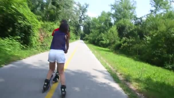 Γυναίκα και άντρας rollerblading σε μια ηλιόλουστη ημέρα στο πάρκο - Πλάνα, βίντεο