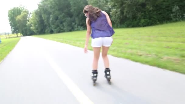 Young attractive woman rollerblading - Video