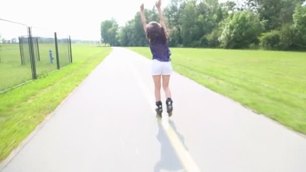 Joven mujer atractiva patinando en el parque
 - Metraje, vídeo
