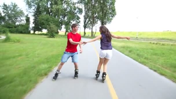 Woman and man rollerblading on a sunny day in park - Footage, Video