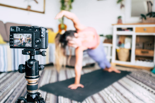 Fitness and home gym workout exercises production from content creator. Concept of healthy job and lifestyle work. People record on camera a pilates fitness lesson. Modern technology freelance work - 写真・画像