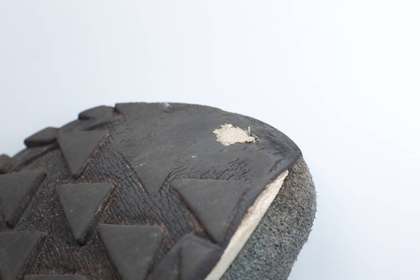 Torn gray leather sneakers. Leather shoes. Shoe repair concept. - Fotó, kép