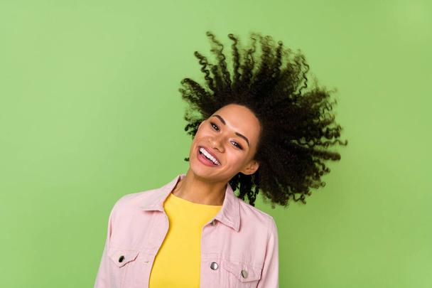 Photo of cheerful good mood female spin head flying hair fooling around enjoy summer isolated on green color background. - Foto, imagen