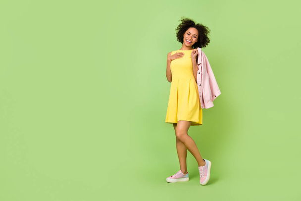Full length photo of adorable sweet lady in pretty yellow dress go on summer date isolated on green color background. - Fotó, kép