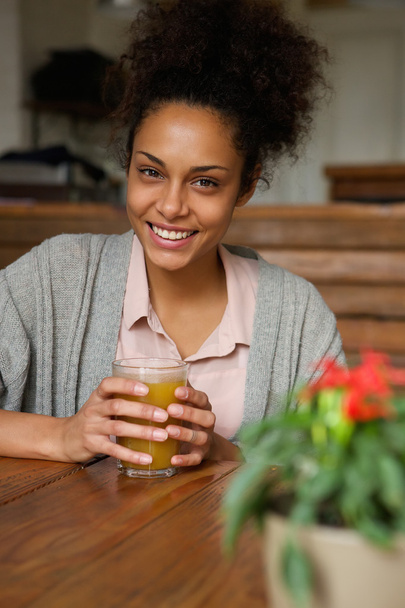 Beautiful woman smiling with glass of orange juice - Photo, image
