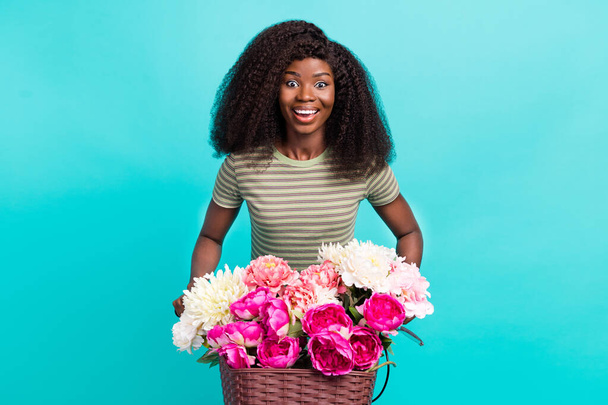 Portrait of cheerful lovely cute girl drive bike toothy smile fresh flowers basket isolated on aquamarine color background. - Φωτογραφία, εικόνα