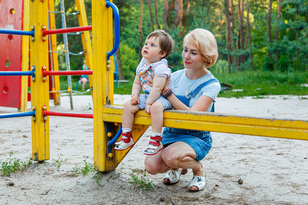 beautiful girl with children on a children's playground close-up - Zdjęcie, obraz