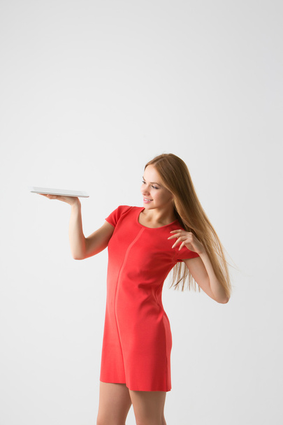 winner woman excited holding tablet pc isolated on white background.  - Zdjęcie, obraz