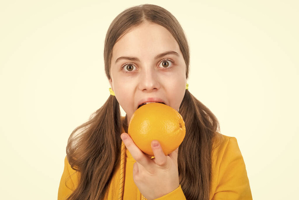 cheerful child eat citrus orange fruit full of vitamins isolated on white, eating. - Foto, Imagem