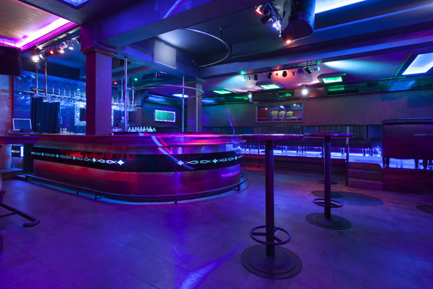 Bar in a modern nightclub with colorful lights - Фото, изображение