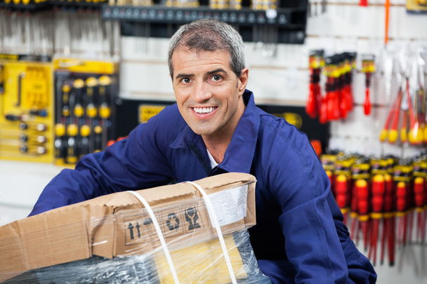 Worker Lifting Tool Package In Hardware Shop - Photo, image