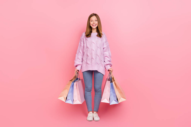 Photo of excited shiny girl knitwear sweater walking shopping smiling isolated pink color background. - Foto, Imagem