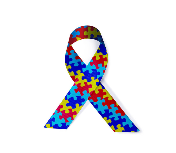World Autism Awareness Day. Colorful puzzle ribbon on white background, top view - Zdjęcie, obraz