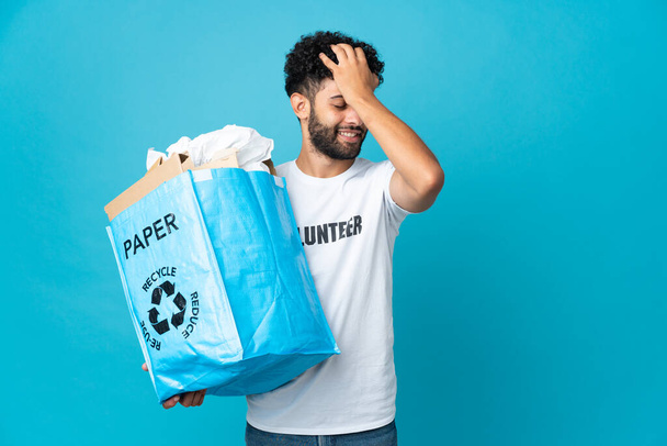 Young Moroccan man holding a recycling bag full of paper to recycle over isolated background has realized something and intending the solution - Photo, Image