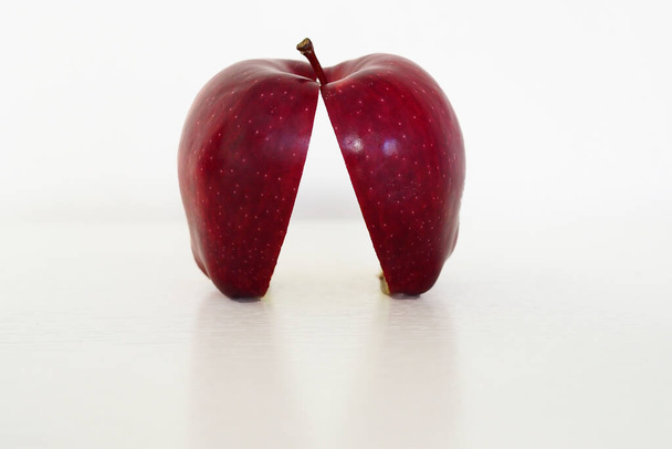 Close up red apple cut in half on white background - Fotoğraf, Görsel