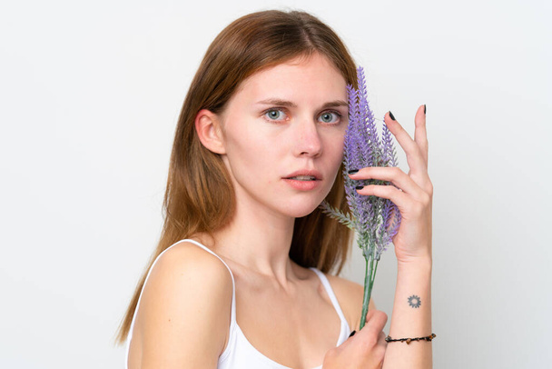 Young English woman holding a lavender plant. Close up portrait - Zdjęcie, obraz