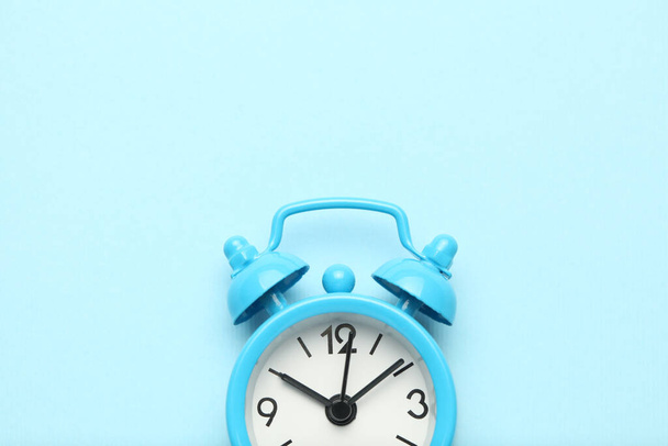 Blue alarm clock isolated on blue background. - Fotografie, Obrázek