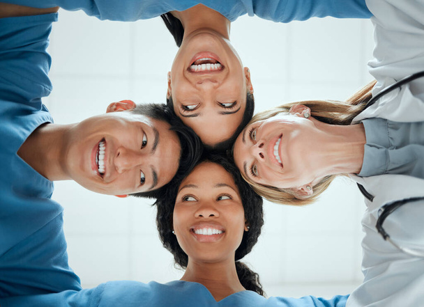 Cropped shot of a group of medical practitioners having a private huddle at work. - 写真・画像
