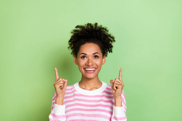 Photo of excited pretty lady dressed pink pullover pointing up empty space isolated green color background. - Φωτογραφία, εικόνα
