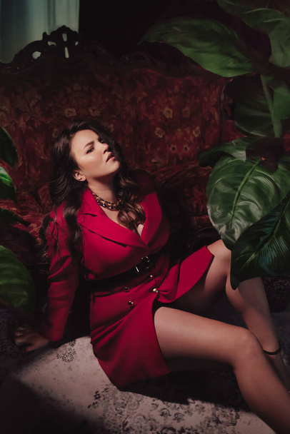 Happy plus size woman with love tourself concept. Portrait of beautiful young woman in red clothes on the background of tropical plants. Self love concept. Overweight concept - Photo, Image