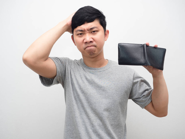 Man strain about no money holding empty wallet in hand - Foto, Bild