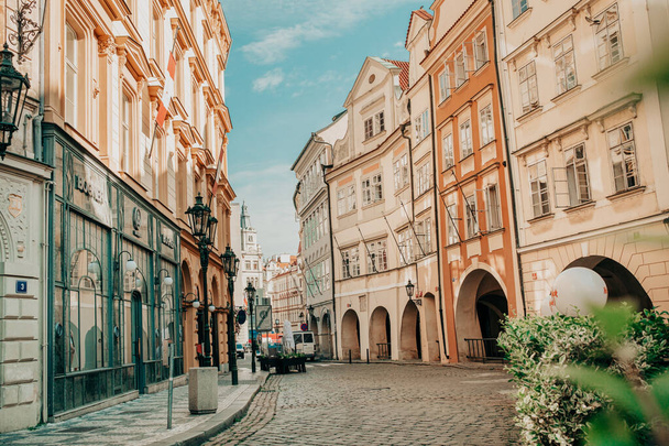 Prague, Czech Republic - July 2022. Beautiful cozy narrow street in old town. Amazing european architecture, historical facades of traditional buildings. High quality photo - Foto, Imagen