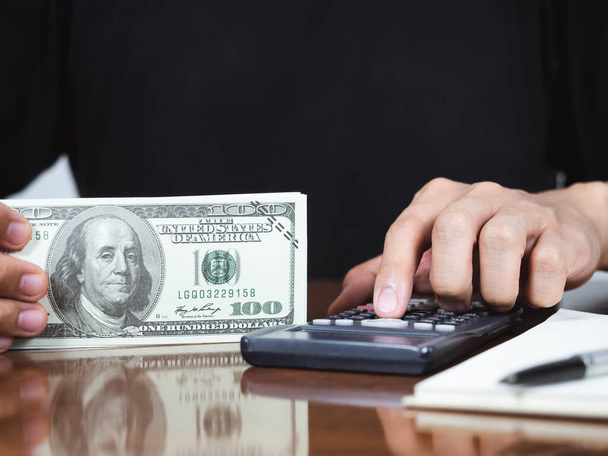 Close up man hand using calculator for accounting with money and financing - Valokuva, kuva