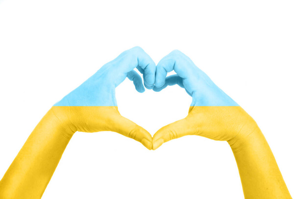 Hands in colors of Ukranian flag making heart, support of Ukraine concept - Zdjęcie, obraz