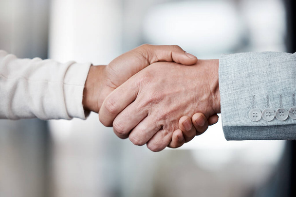 Shot of two unrecognizable businespeople shaking hands in an office at work. - Φωτογραφία, εικόνα