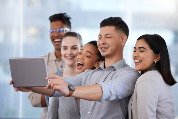 Знімок групи молодих бізнесменів, які беруть селфі з цифровим планшетом в сучасному офісі
. - Фото, зображення