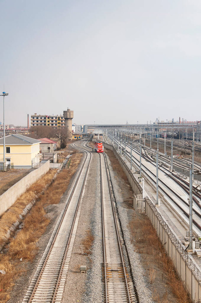 Railroad tracks and the zhaodong train stop through a Tier 5 city in Northeast China in Heilongjiang province. - Zdjęcie, obraz