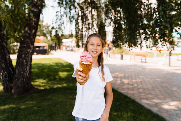 Funny child girl with ice cream cone in waffle cup. Summer sweets food. Creative advert for ice cream stand and shop - Foto, Bild