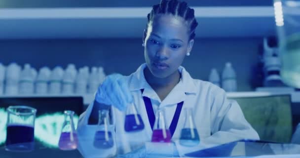 Професійний біохімік тестує різноманітні рідини та аналізує результати її хімічного випробування в медичній дослідницькій лабораторії. Вчений змішує органічну рідину в колбі в лабораторії
 - Кадри, відео