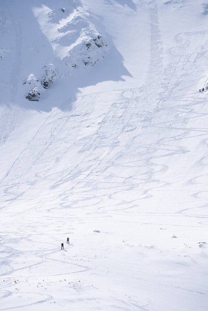 Hikers going through alpine snowy terrain during winter, vertical shot, Slovakia, Europe. - Фото, зображення