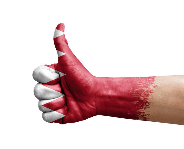 Рука робить великий палець, намальований прапором Бахрейну
 - Фото, зображення