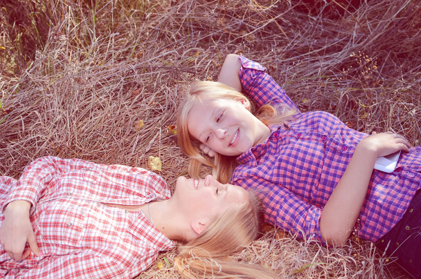 Girls relaxing on hay - Фото, изображение