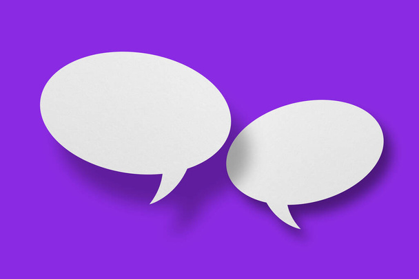 White paper in the shape of speech bubbles against a purple background. Communication bubbles.Design - Photo, Image