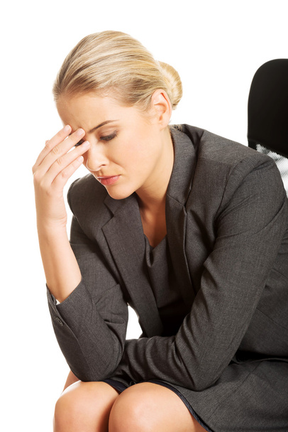 Depressed businesswoman sitting on armchair - Фото, зображення