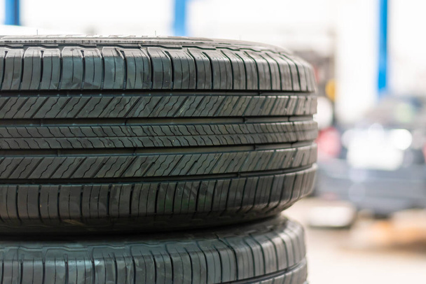 Tires for wheels are sold in car service centers. Closeup, copy space, Blurred background. - Photo, image