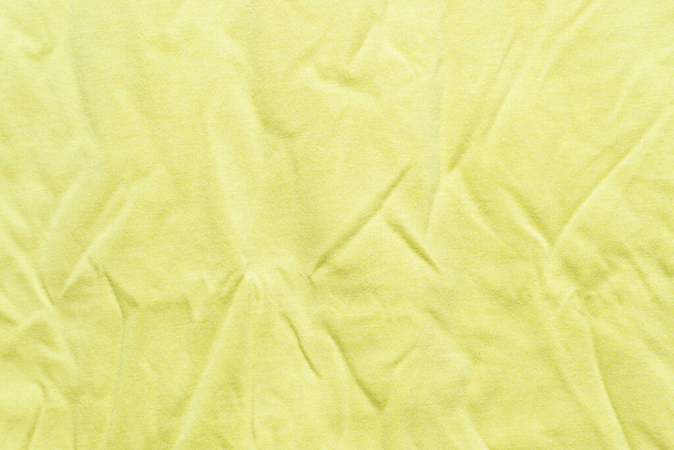 Crumpled texture of green textile clothing wallpaper - Photo, Image